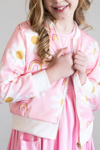 Girls pink satin jacket with white and yellow daisy flower print and rainbow details
