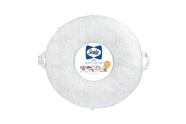Sealy baby floor cushion in light gray with orange dots and side handles for easy carrying