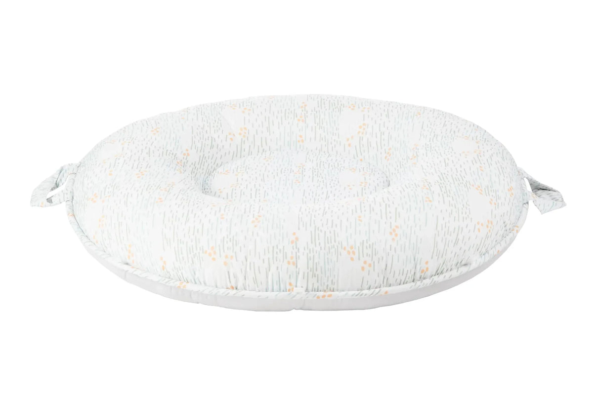 Goosewaddle Sealy floor cushion in white with subtle orange and gray pattern, designed for newborns