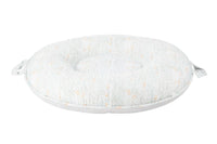 Goosewaddle Sealy floor cushion in white with subtle orange and gray pattern, designed for newborns