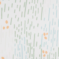 White sealy pouf for toddlers with green, blue, and orange abstract dot and line pattern