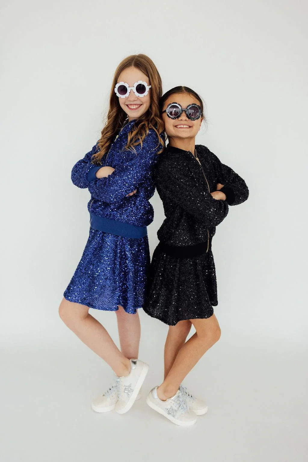 Girls blue and black sequin jackets by Mila & Rose with long sleeves and matching skirts