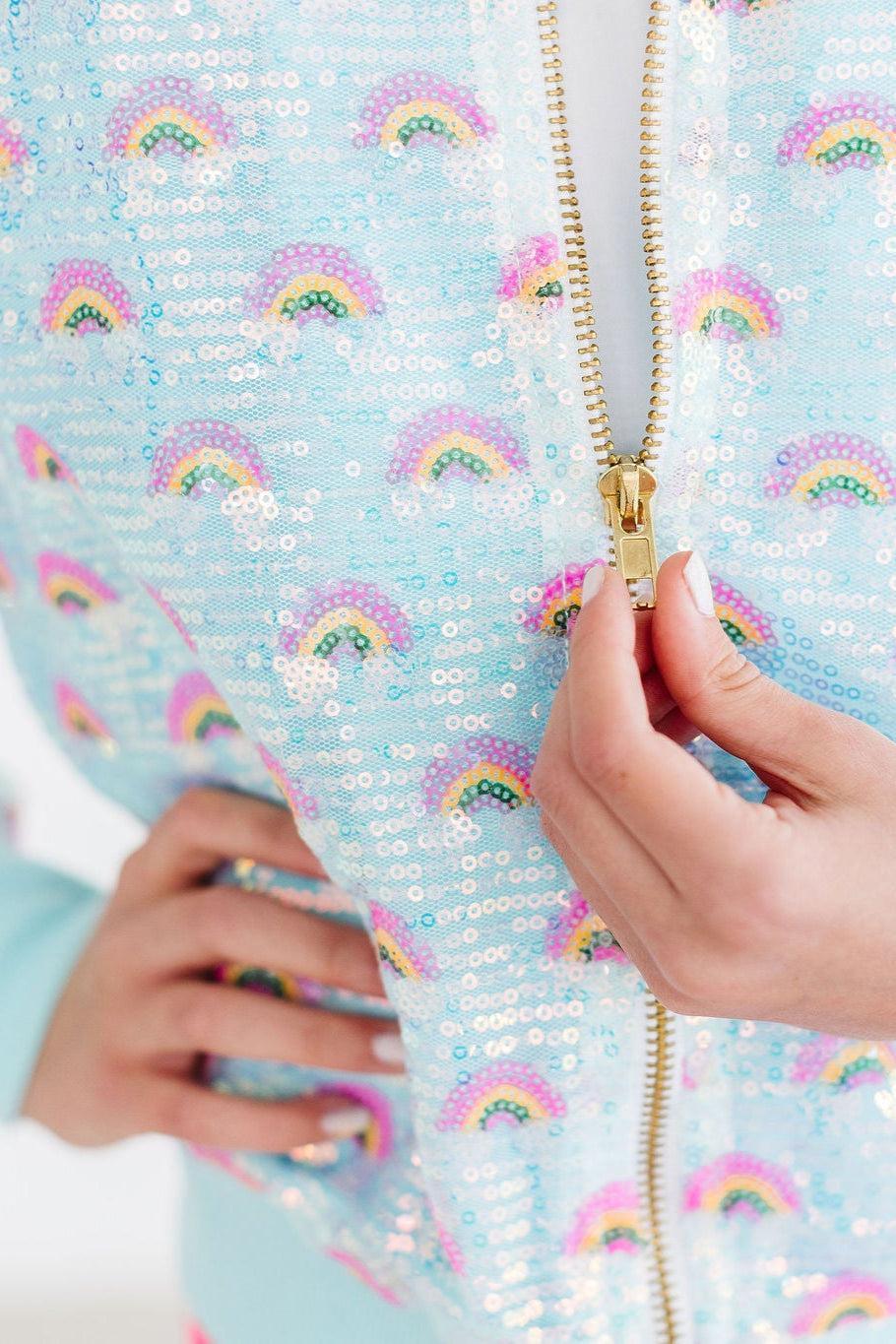 Girls light blue sequin jacket with rainbow pattern and gold zipper detail