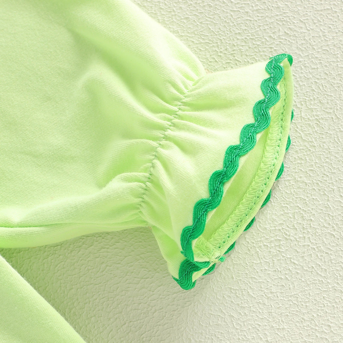 Light green cotton baby romper sleeve with green trim in shamrock embroidered baby bubble style