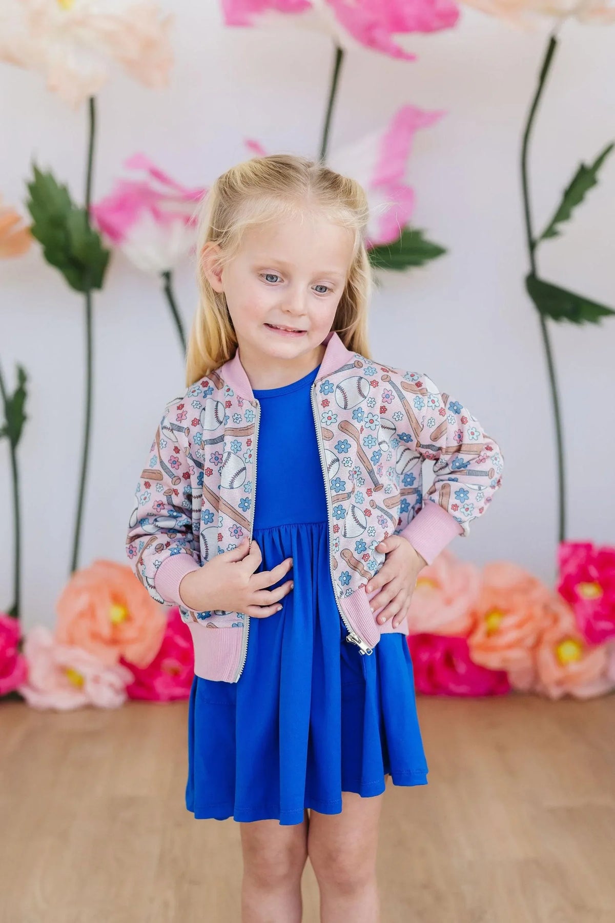 Girls pink patterned shimmer jacket with long sleeves by Mila & Rose over blue dress
