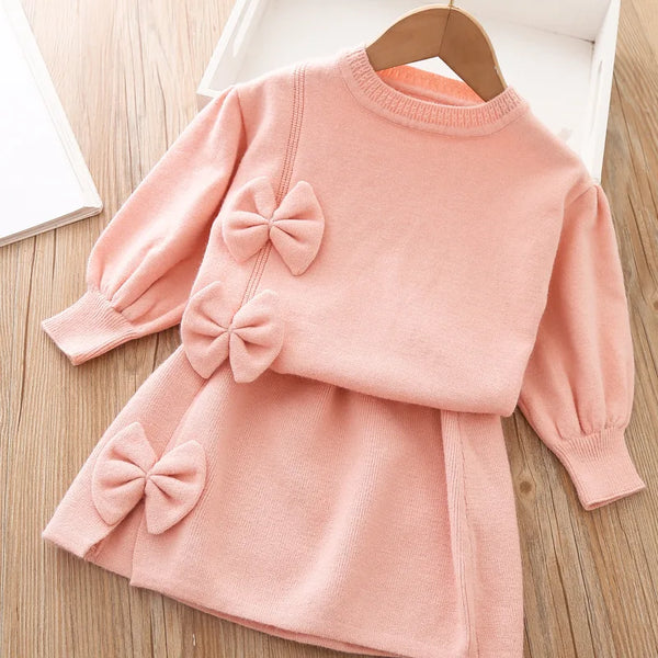 Pink baby skirt set with long sleeve top and three decorative bows for girls