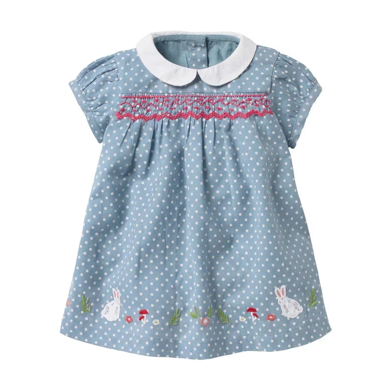 baby blue smocked dress with white polka dots, pink smocking, white collar, and bunny embroidery