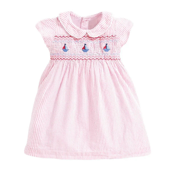 baby pink smocked dress with sailboat embroidery and Peter Pan collar for infants