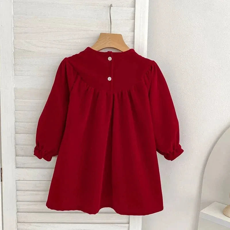 Baby red smocked dress with long sleeves and button details at the back