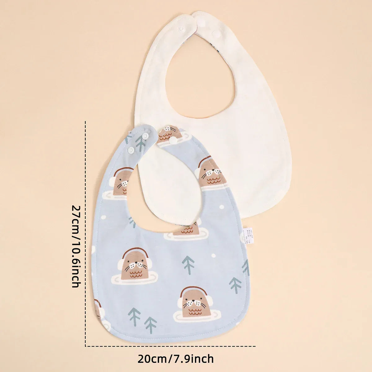 Soft cotton baby bib set with blue otter print and plain white bib, sized for infants