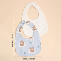 Soft cotton baby bib set with blue otter print and plain white bib, sized for infants
