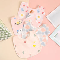 Soft cotton baby bib set with pastel pink and cream colors for infants with cute printed designs