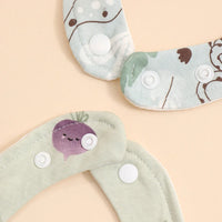 soft cotton baby bib set in pastel green and blue with animal and vegetable prints, adjustable snap closures