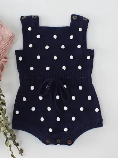 Navy blue soft knit baby romper with white polka dots for infants with button straps