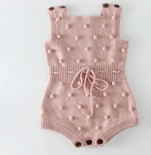 Pink soft knit baby romper for babies with textured bobble details and adjustable shoulder straps