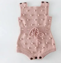 Pink soft knit baby romper for babies with textured bobble details and adjustable shoulder straps