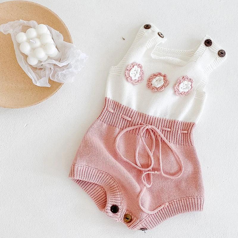 soft knit baby romper in white and pink with flower details for infants