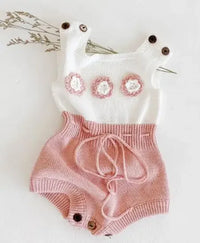 Soft knit baby romper in white and pink with flower appliques and button straps for infants