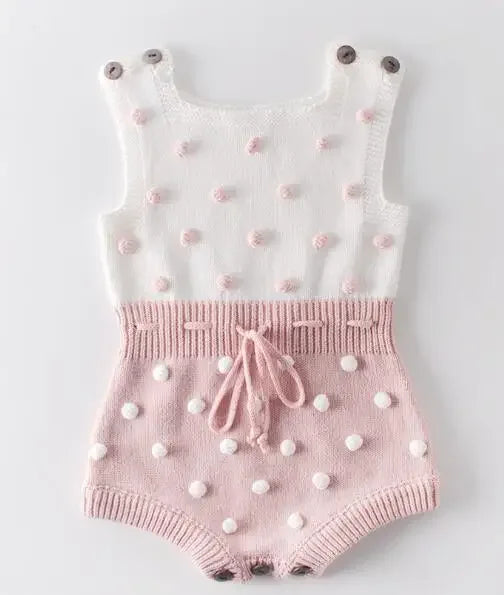 soft knit baby romper in white and pink for infants with button straps and textured dot detail