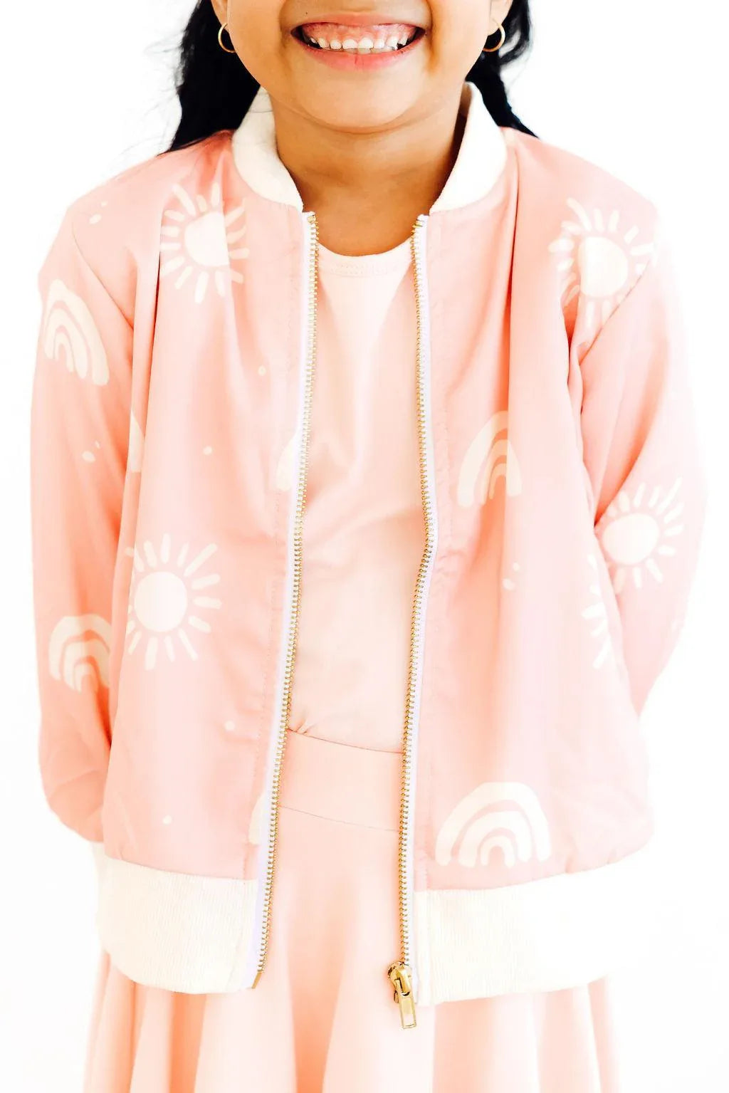 Soft pink satin jacket for girls with white sun and rainbow print, long sleeve, and zipper closure