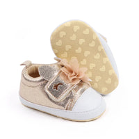 gold and white soft sole baby shoes with flower decoration for infants showing sole with heart patterns