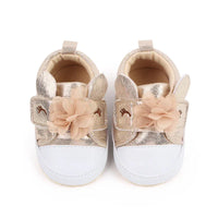 gold and white soft sole baby shoes with flower and bunny ear design for infants