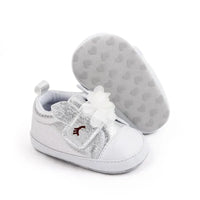 silver soft sole baby shoes with white flower and bunny ears for infants, one shoe upright and one showing sole