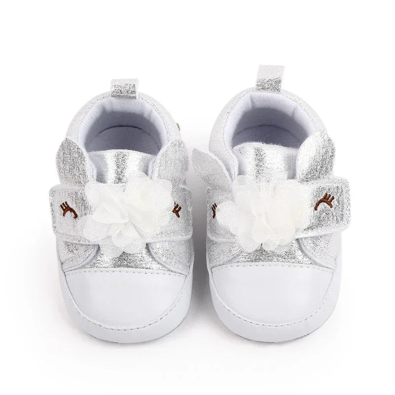 Pair of silver and white soft sole baby shoes for infants with flower and reindeer detail