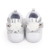 Pair of silver and white soft sole baby shoes for infants with flower and reindeer detail
