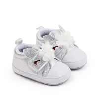 Silver soft sole baby shoes with white flower and bunny ear details for infants