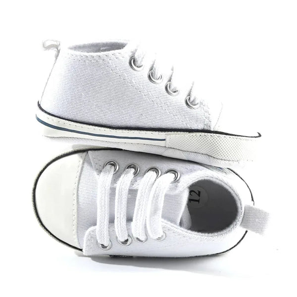 White soft sole baby shoes for infants size 12 shown from side and top view