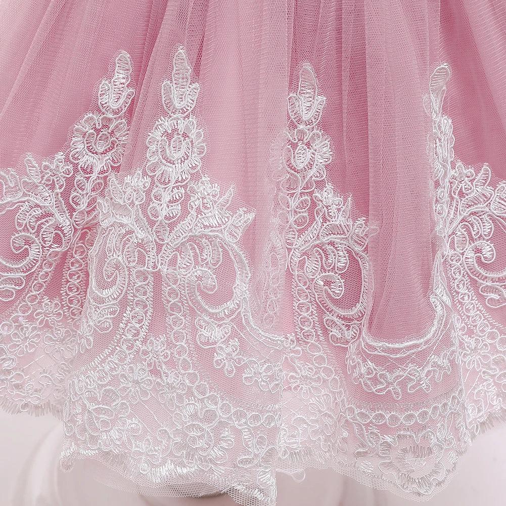 baby pink special occasion dress with intricate white lace embroidery hem detail