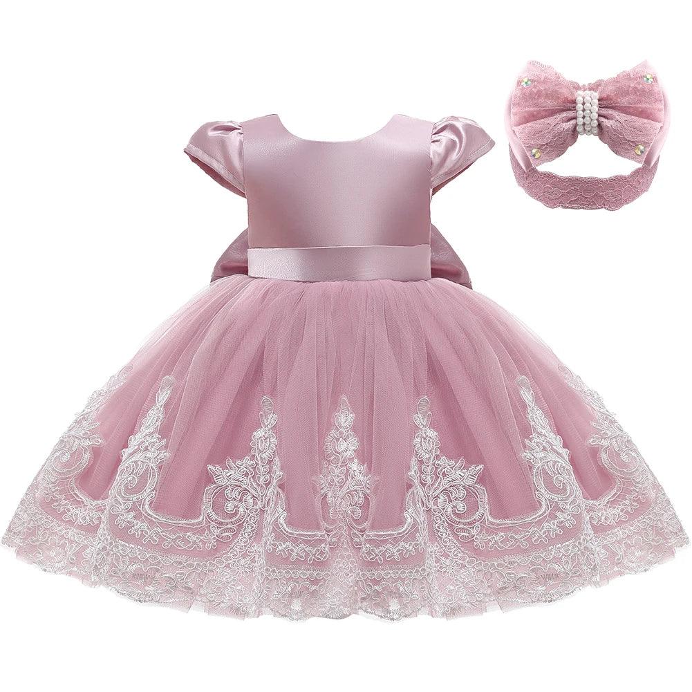 pink special occasion dress for babies with satin top and lace embroidered tulle skirt with matching headband