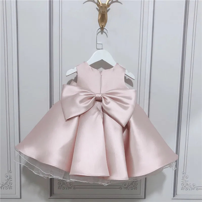 baby pink satin special occasion dress with large bow back for infants