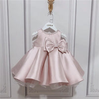 baby pink special occasion dress with large bow and sleeveless design for infants