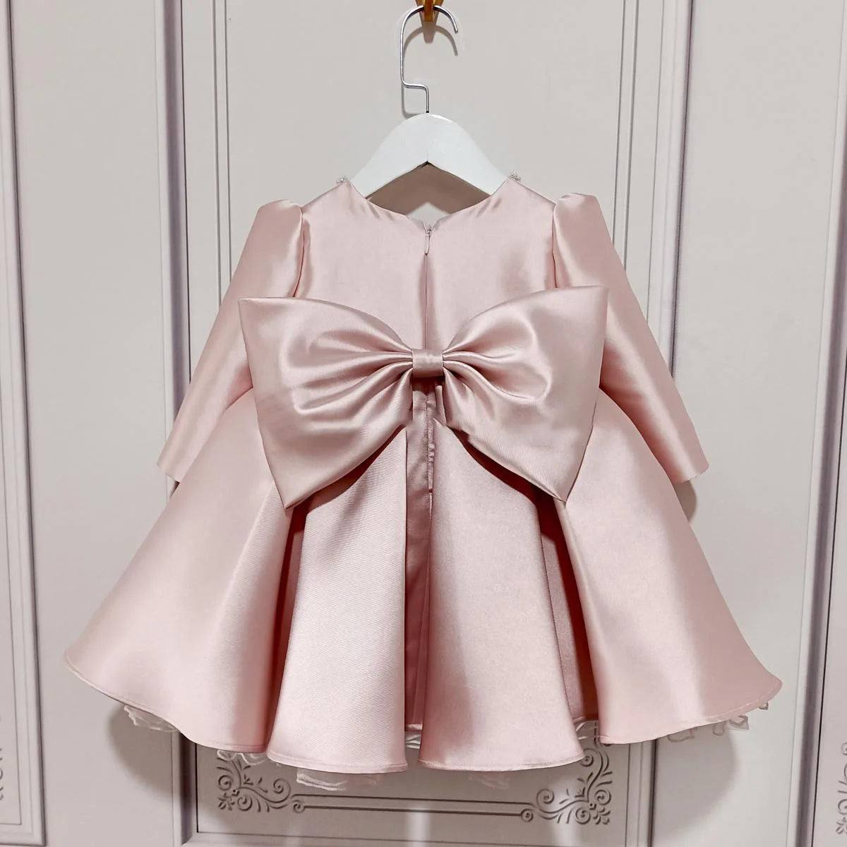 baby pink special occasion dress with large satin bow back for infants and toddlers