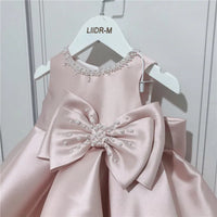Baby girls pink special occasion dress with pearl embellished neckline and large bow