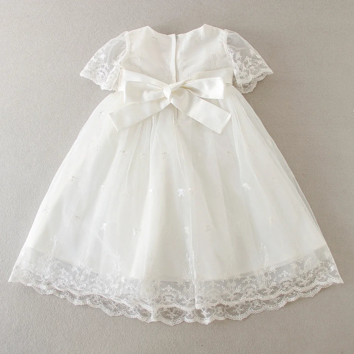 white baby special occasion dress with lace sleeves and bow, delicate embroidered tulle skirt