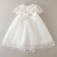 white baby special occasion dress with lace sleeves and bow, delicate embroidered tulle skirt