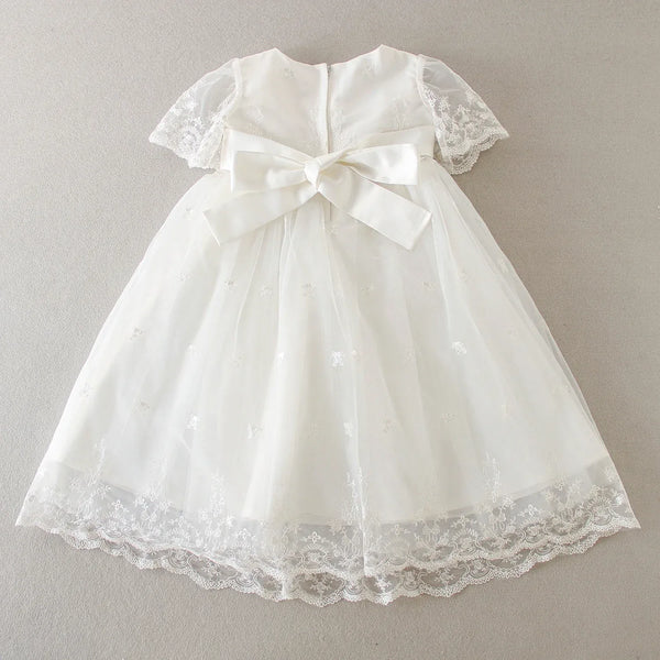 white baby special occasion dress with lace sleeves and bow, delicate embroidered tulle skirt