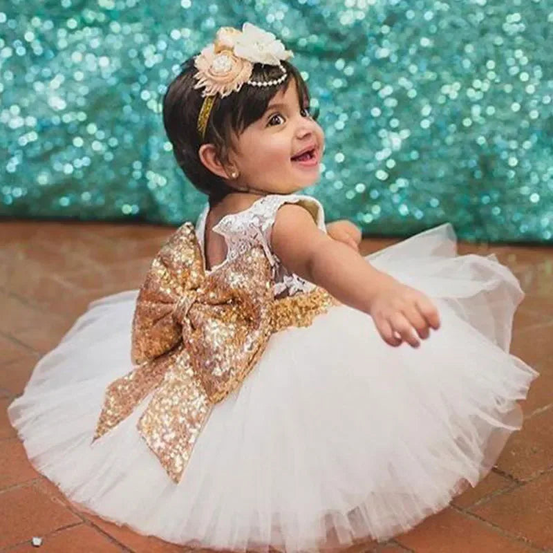 Baby girls white and gold special occasion dress with large gold sequin bow and tulle skirt