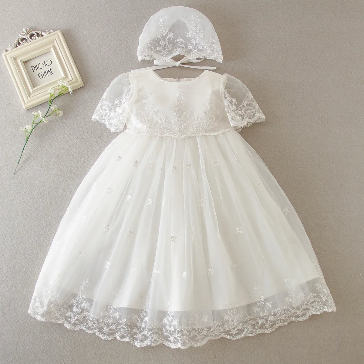 White special occasion dress for babies with lace sleeves and matching lace bonnet