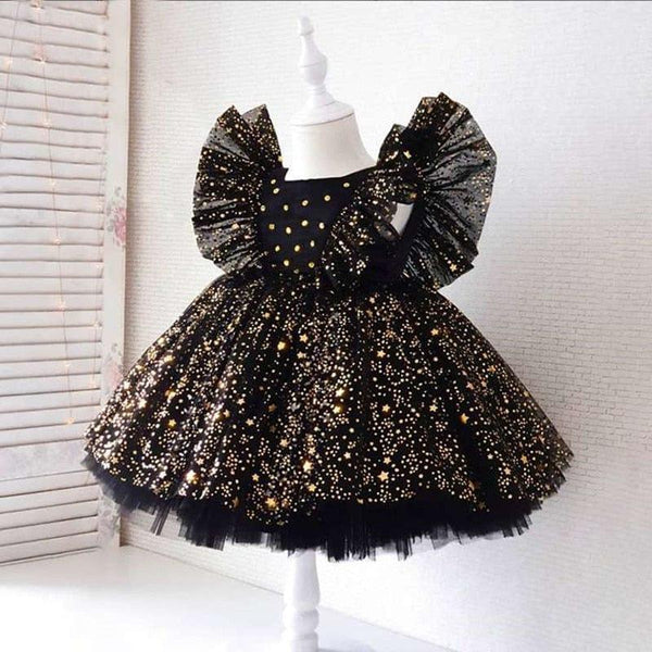girls black special occasion dress with lace and gold star details, sleeveless with ruffled shoulders