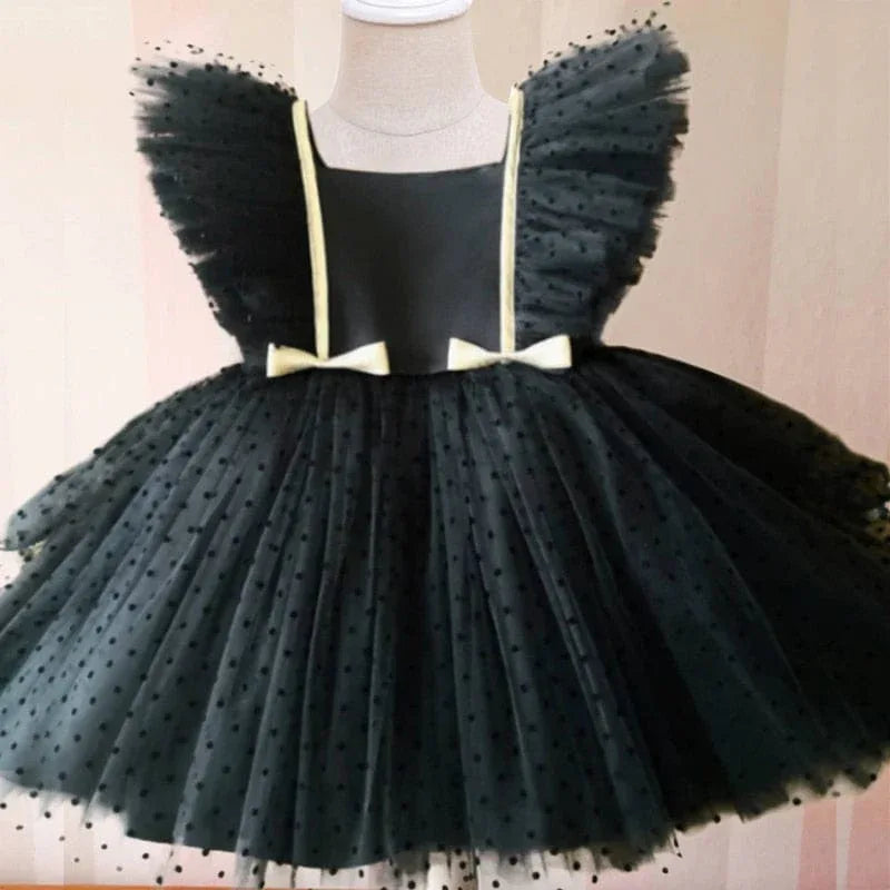 Girls black special occasion dress with lace featuring puffed sleeves and bow accents for toddlers