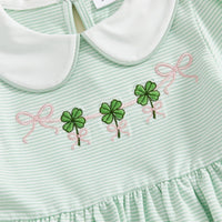 Close-up of green and white striped St. Patrick's Day dress for little girls with white collar and embroidered shamrocks