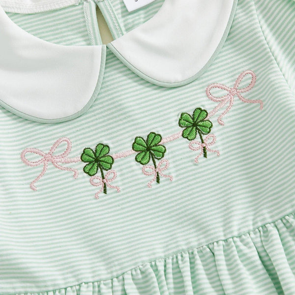 Close-up of green and white striped St. Patrick's Day dress for little girls with white collar and embroidered shamrocks