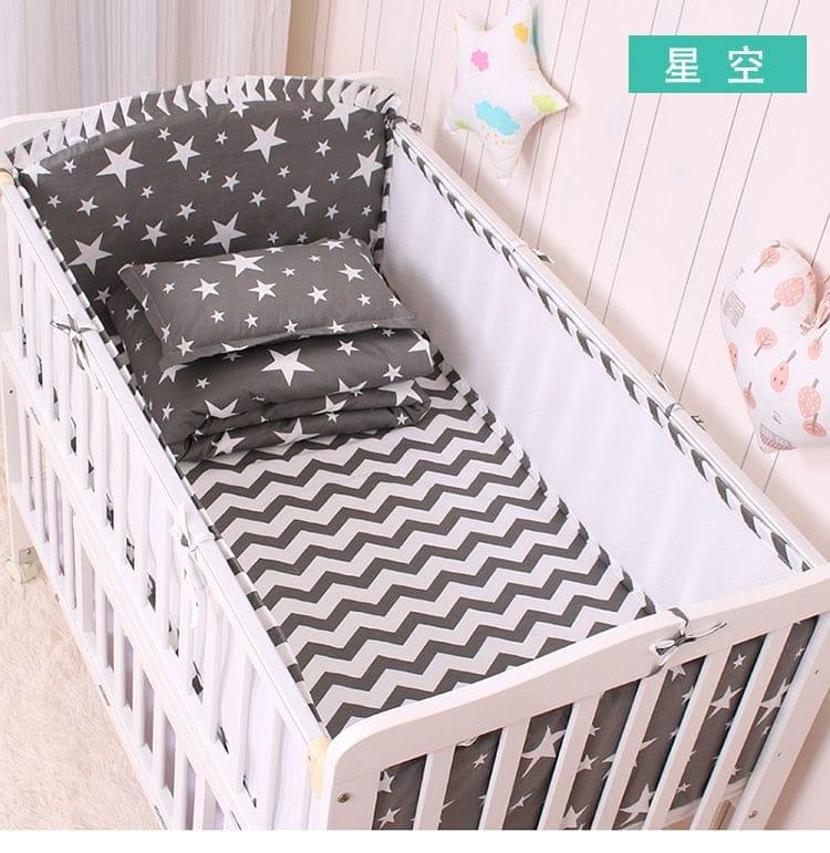 Gray starry night baby bedding set for infants with star and chevron patterns in crib