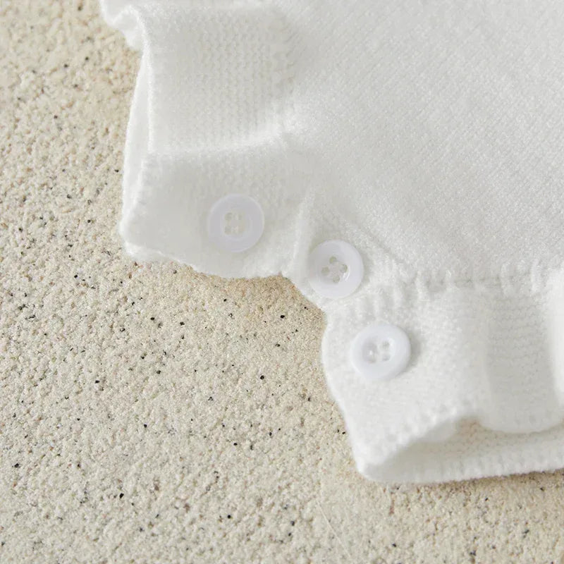 white strawberry baby romper for girls with button closure and ruffle detail