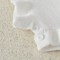white strawberry baby romper for girls with button closure and ruffle detail