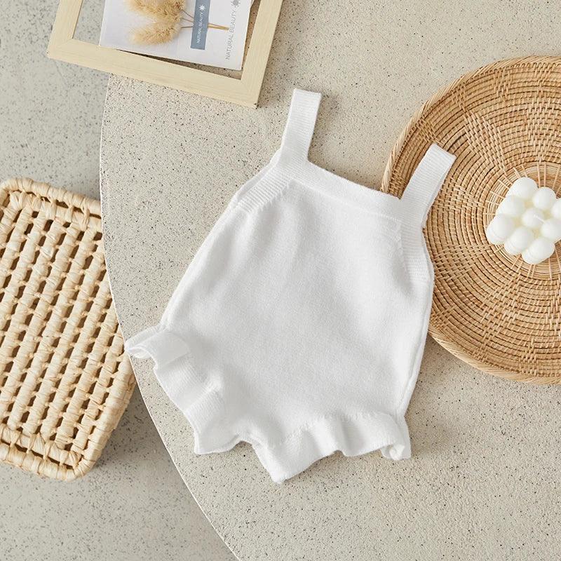 white baby romper for girls with ruffle trim, sleeveless, newborn to toddler size